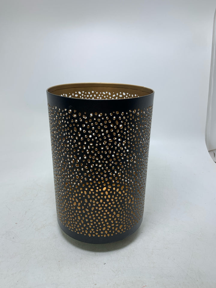 FOOTED METAL PIERCED PILLAR CANDLE HOLDER.
