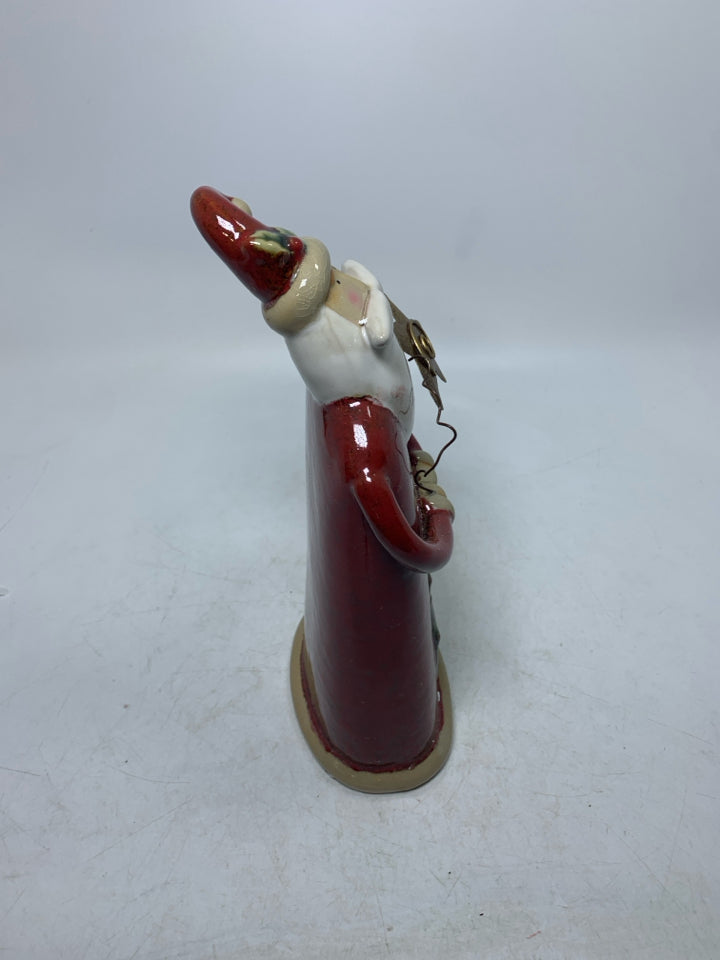 CERAMIC SANTA STANDING W/ HANDS TOGETHER HOLDING GOLD STAR.