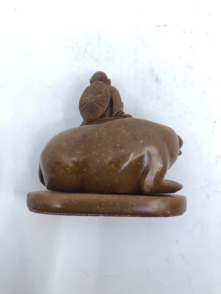 BROWN BULL & MAN FIGURINE ON WOOD SLAB.