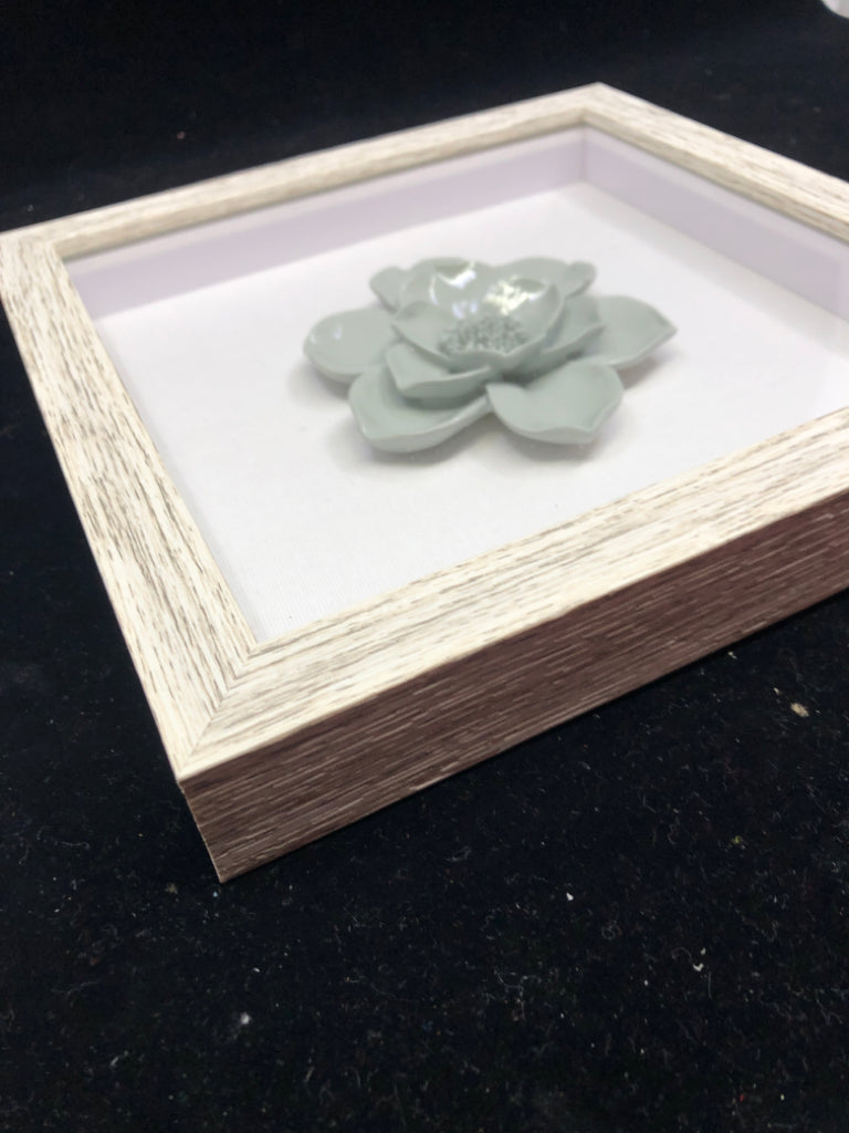 TEAL FLOWER IN SHADOW BOX WALL ART IN GREY FRAME.