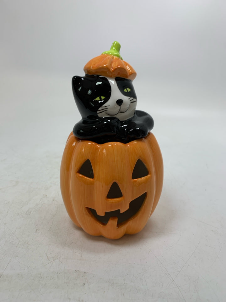 BLACK/WHITE CAT POPPING OUT OF JACKO LANTERN TEALIGHT HOLDER.