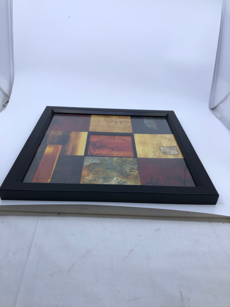 RED SQUARE PATTERN W BLACK LEAVES WALL ART IN BLACK FRAME.