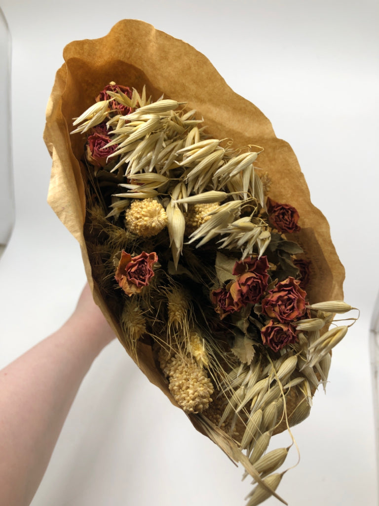 FAUX ROSE AND WILDFLOWER BOUQUET WRAPPED IN PAPER.
