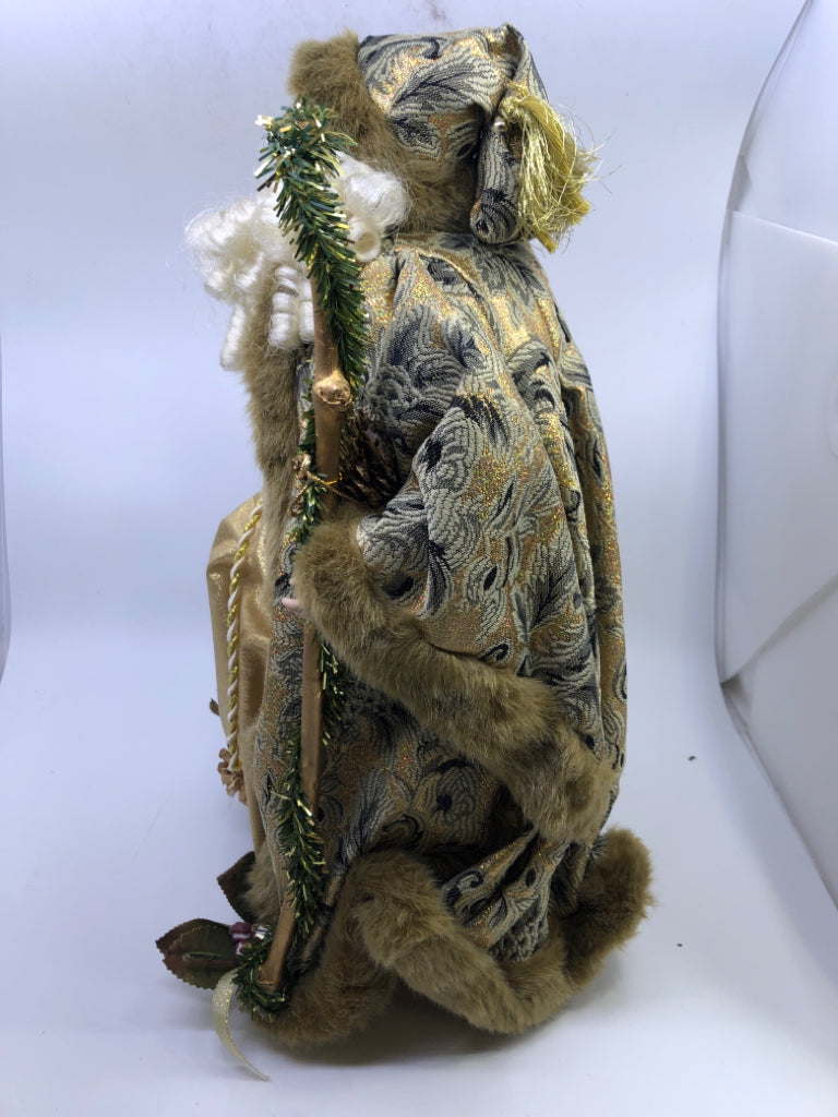 STANDING HOLLOW SANTA IN GOLD JACKET W/ PINECONES HOLDING STAKE.