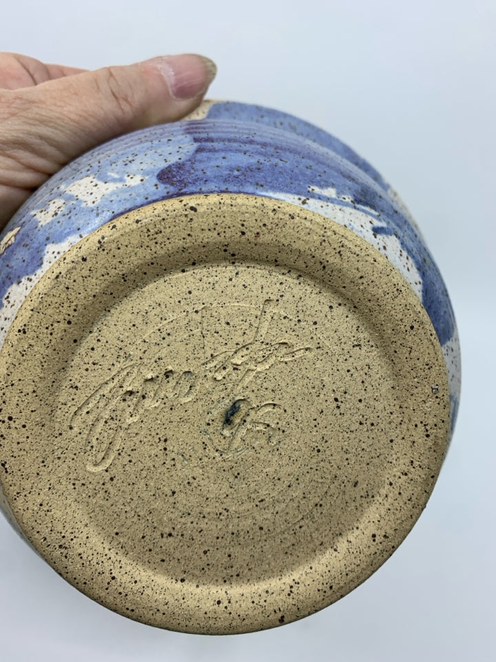 2 NESTING TAN AND BLUE POTTERY BOWLS.