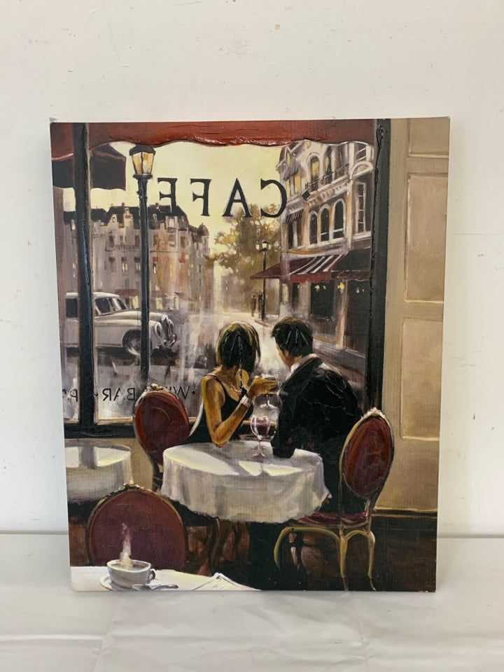 COUPLE SITTING IN A CAFE LOOKING OUT THE WINDOW W/ WINE CANVAS.