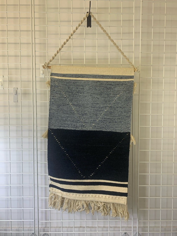 BLUE AND CREAM FABRIC WALL HANGING.