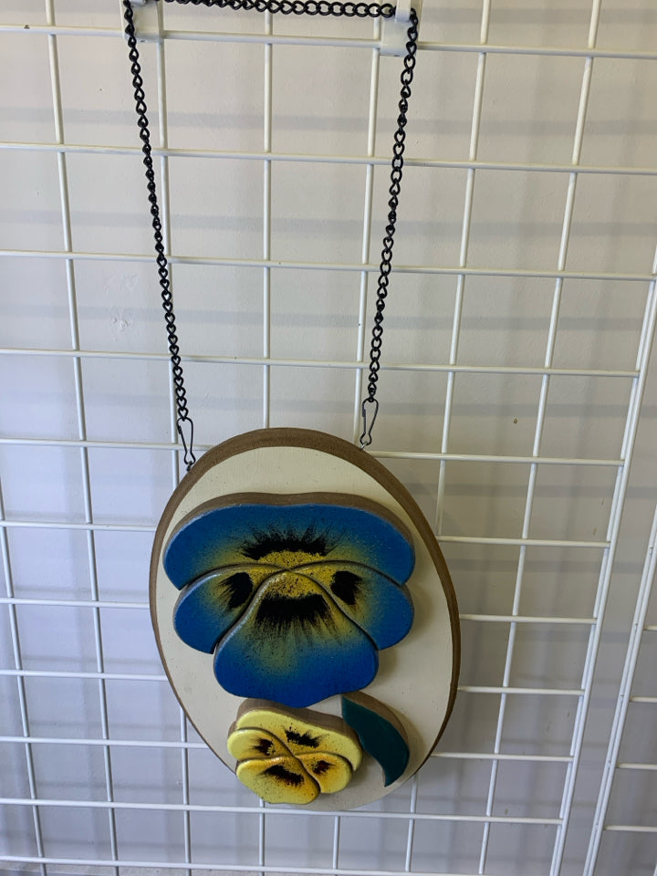 OVAL WOODEN BLUE AND YELLOW FLORAL WALL HANGING.