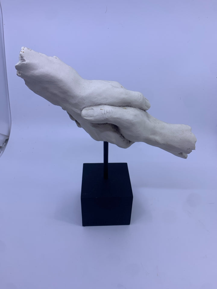 HOLDING HANDS ON HEAVY METAL BLOCK SHELF DECOR.