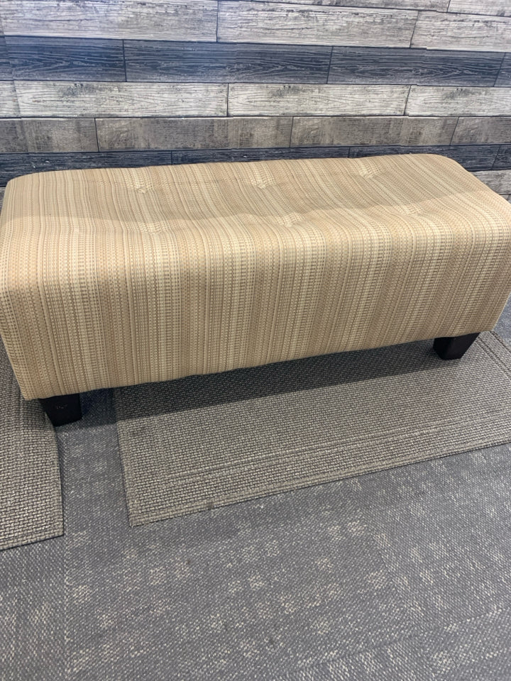 TAN OTTOMAN BENCH, SILK WEAVE TEXTURE W/BUTTON DETAIL.