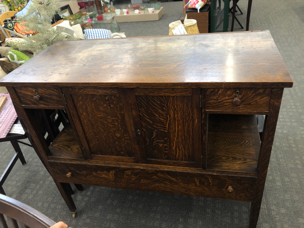 VTG LARGE BUFFET TABLE W 3 DRAWERS AND CABINET ON WHEELS.