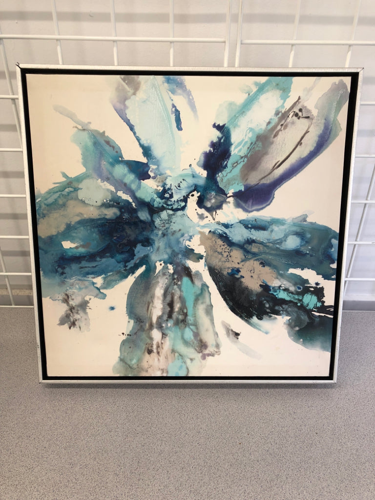 BLUE W/BLACK WATERCOLOR STYLE FLOWER ON FRAMED CANVAS.