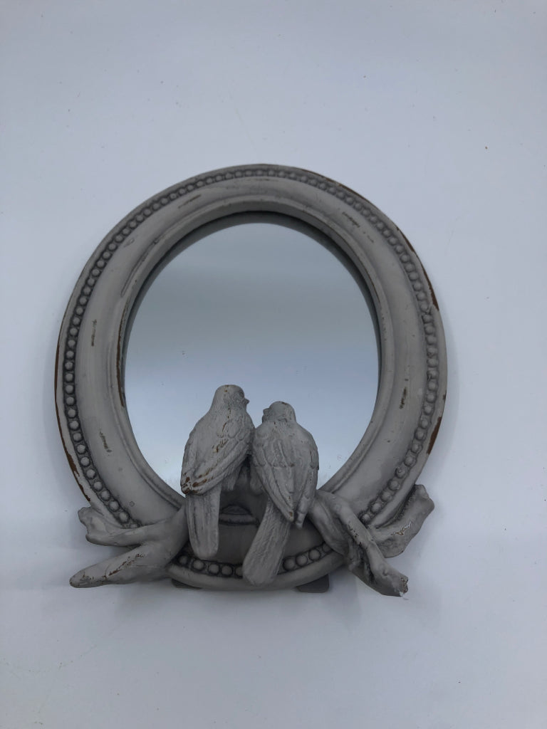 SMALL DISTRESSED OVAL MIRROR W/ EMBOSSED BIRDS.