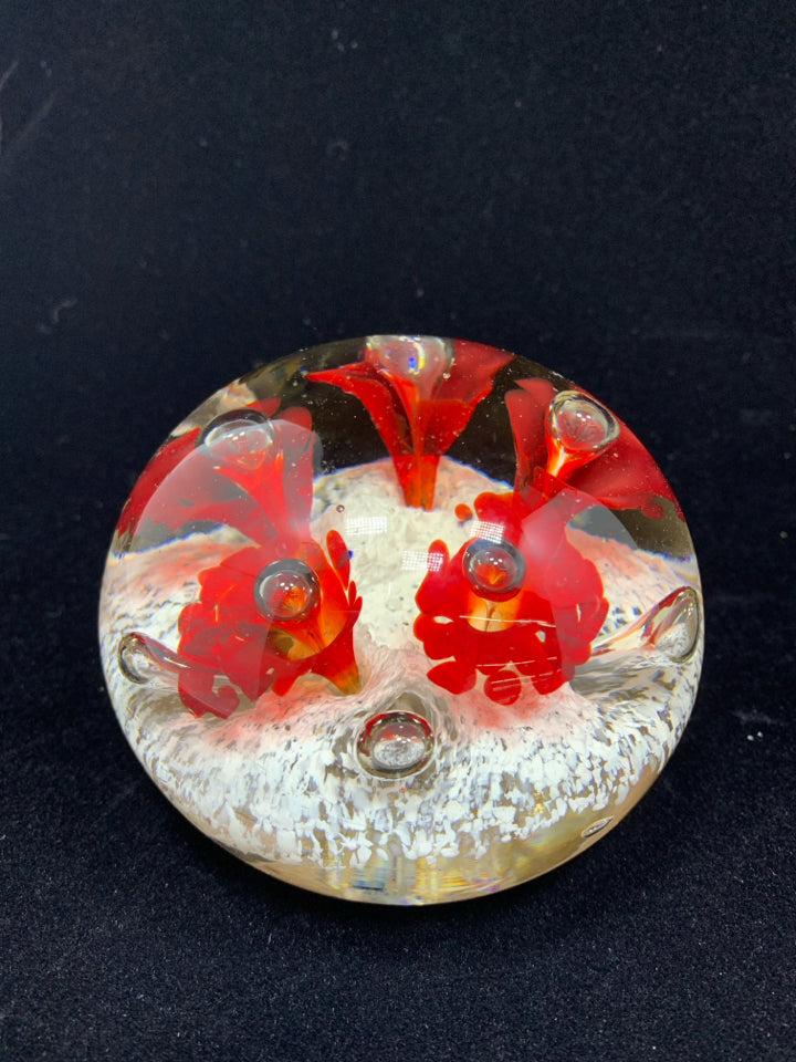 CLEAR GLASS PAPERWEIGHT W/WHITE/RED FLORAL DESIGN.