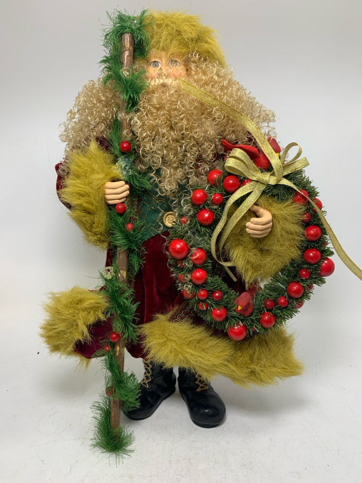 CURLY HAIRED SANTA W/ DARK RED COAT HOLDING WREATH.
