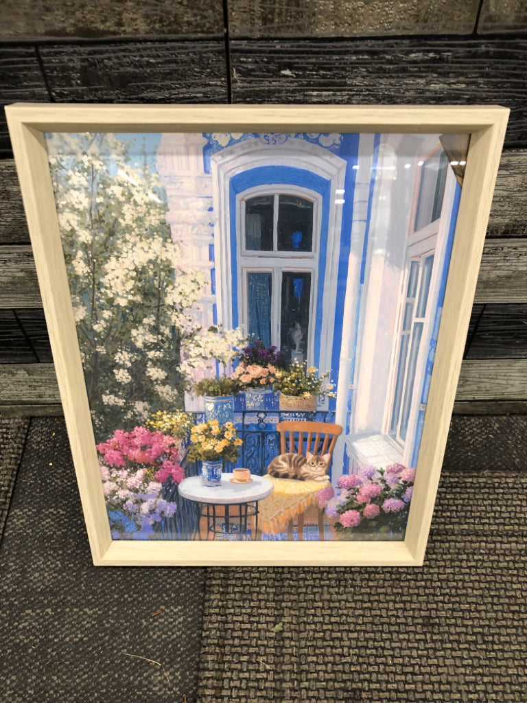 CAT IN FRONT OF CAFE AND FLOWERS ART IN LIGHT WOOD FRAME.