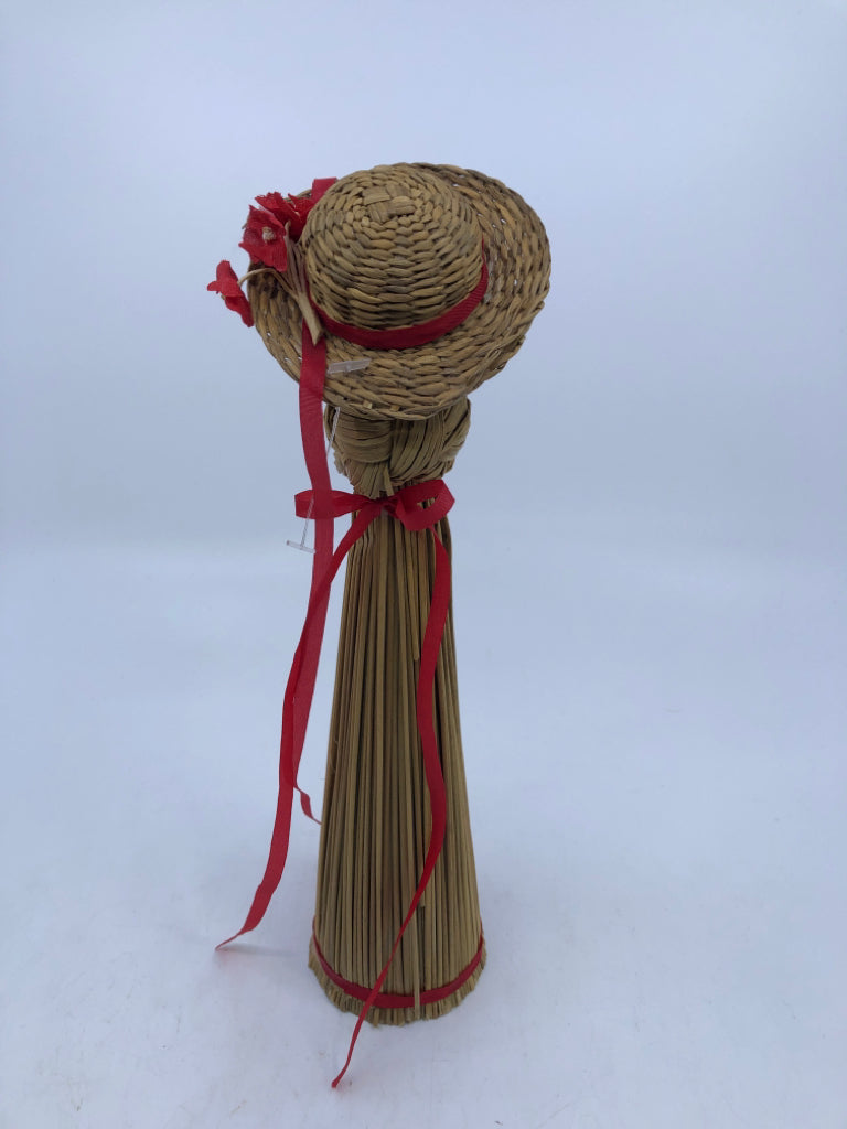 STRAW LADY W/HAT AND RED RIBBON.