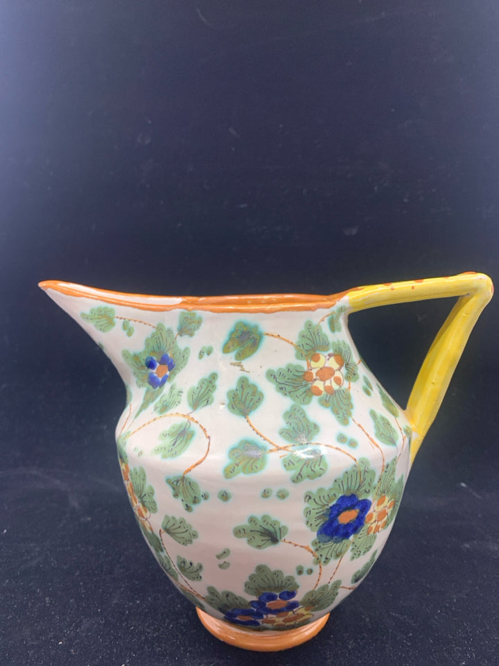 PAINTED UNIQUE PITCHER W YELLOW HANDLE.