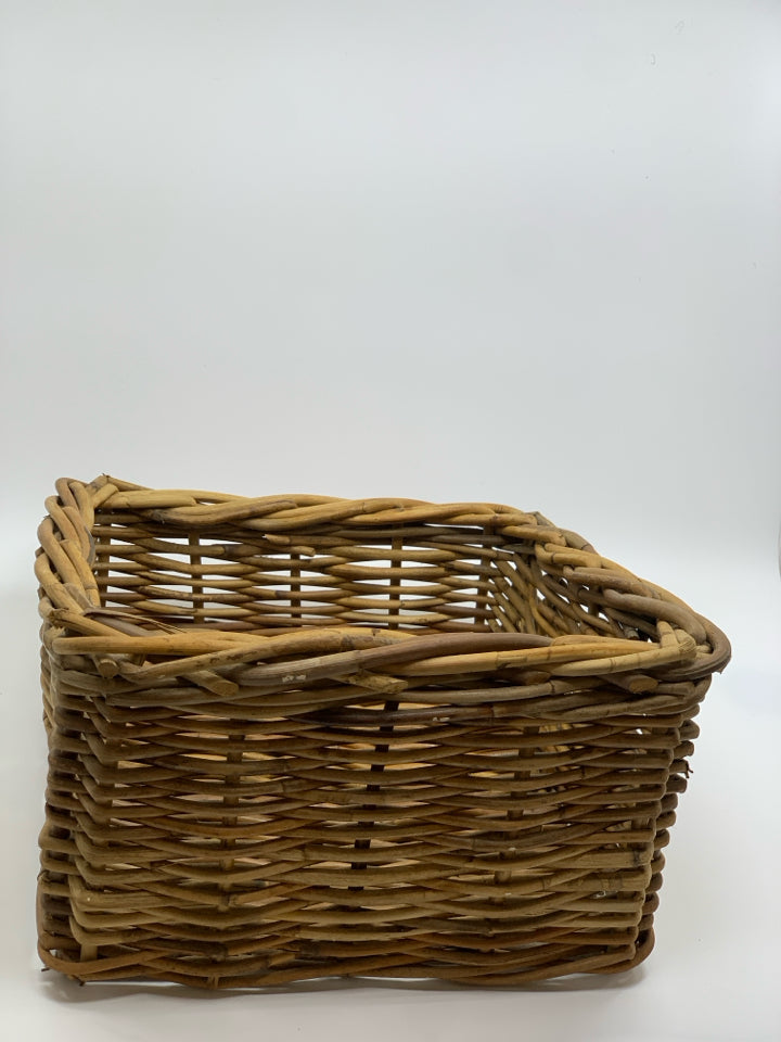 SLANTED BROWN WICKER BASKET.