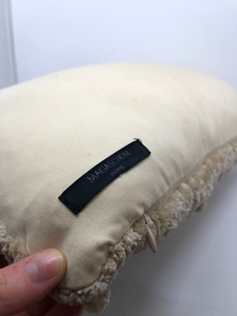 FUZZY TAN THROW PILLOW.