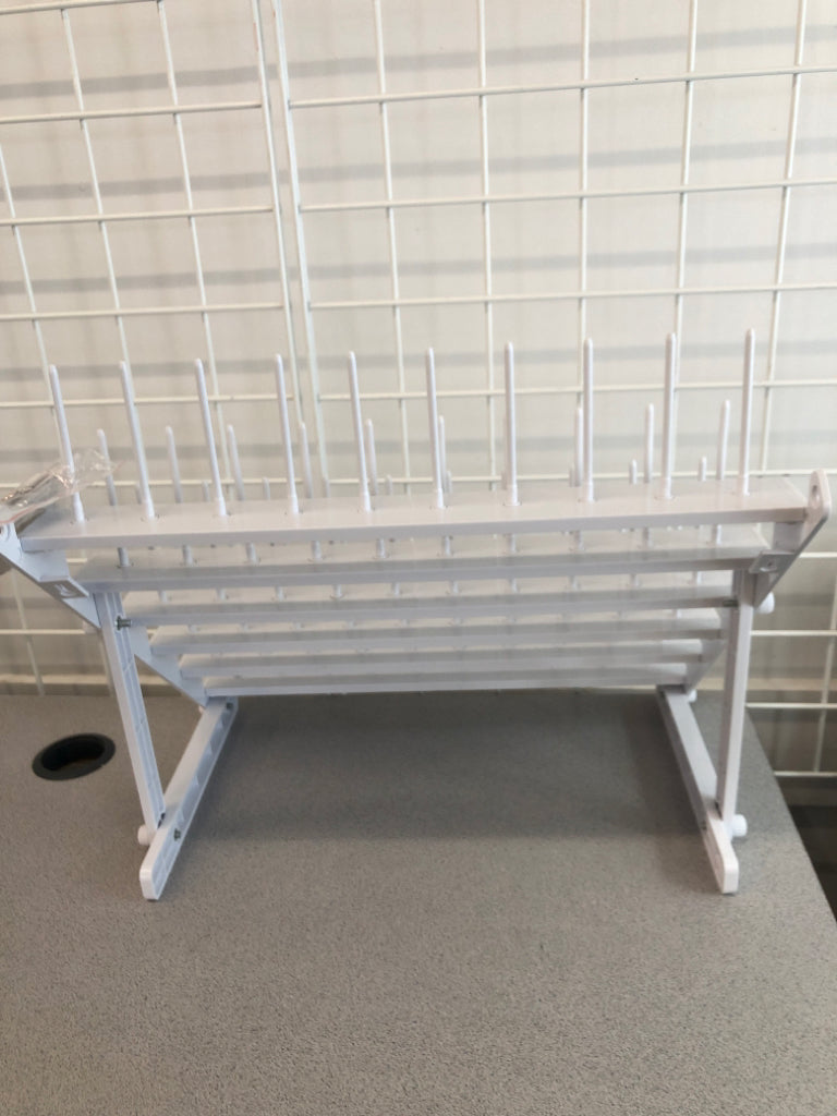 WHITE PLASTIC YARN SPOOL ORGANIZER.