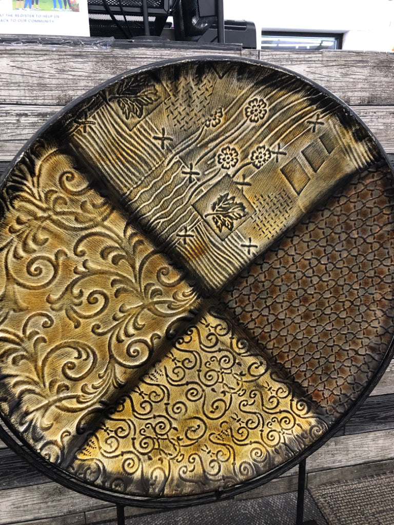 LEAF EMBOSSED ROUND METAL CENTERPIECE ON WOOD STAND.