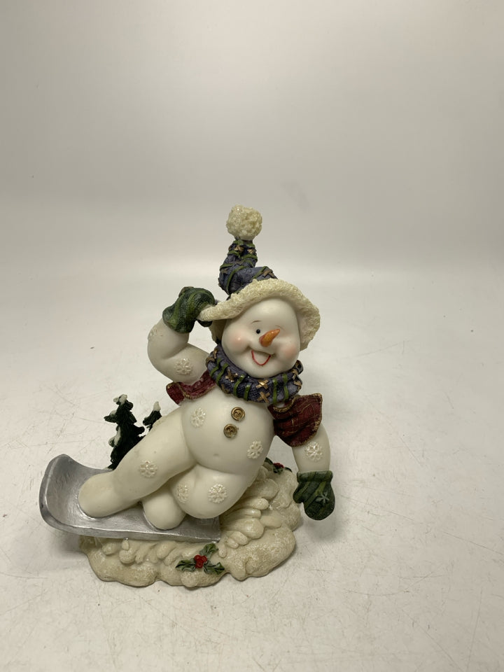 RESIN SNOWMAN ON SNOWBOARD.