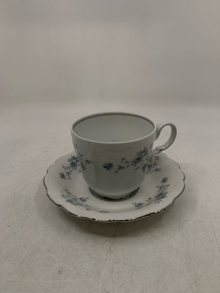 WHITE TEA CUP W/ BLUE FLOWERS & SILVER DETAILS.