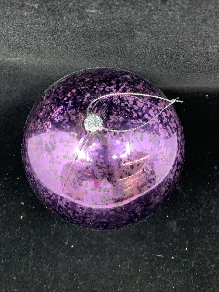 LARGE PLASTIC PURPLE ORNAMENT.