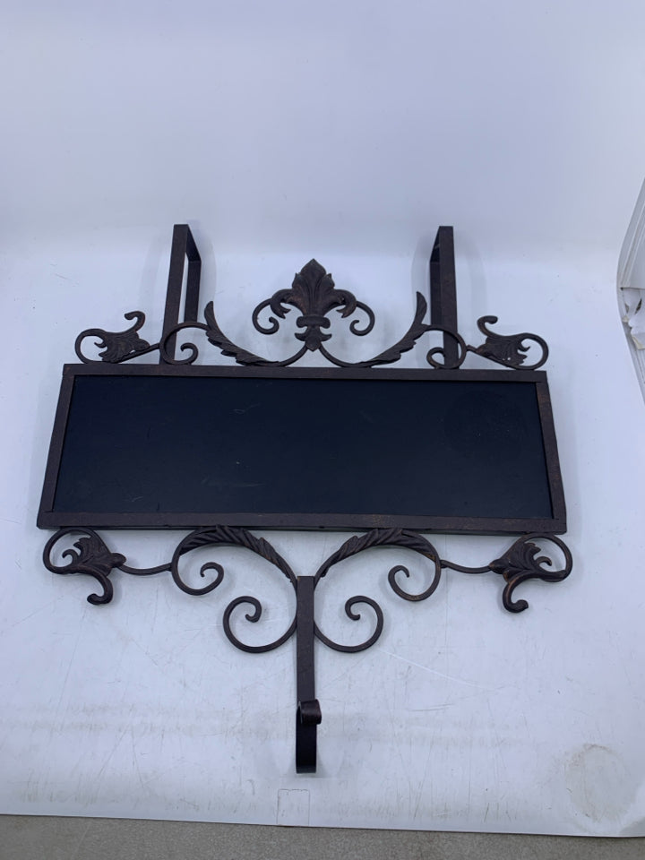 BROWN METAL SCROLL OVER THE DOOR HOOK W/ CHALK BOARD FRONT.