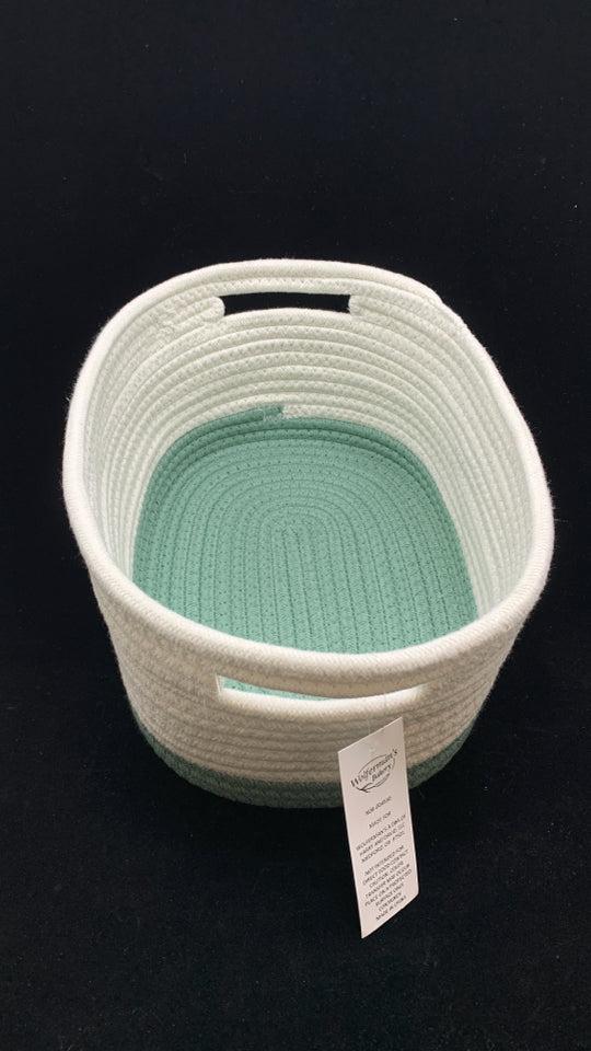 GREEN/WHITE WOVEN OVAL STORAGE BIN.