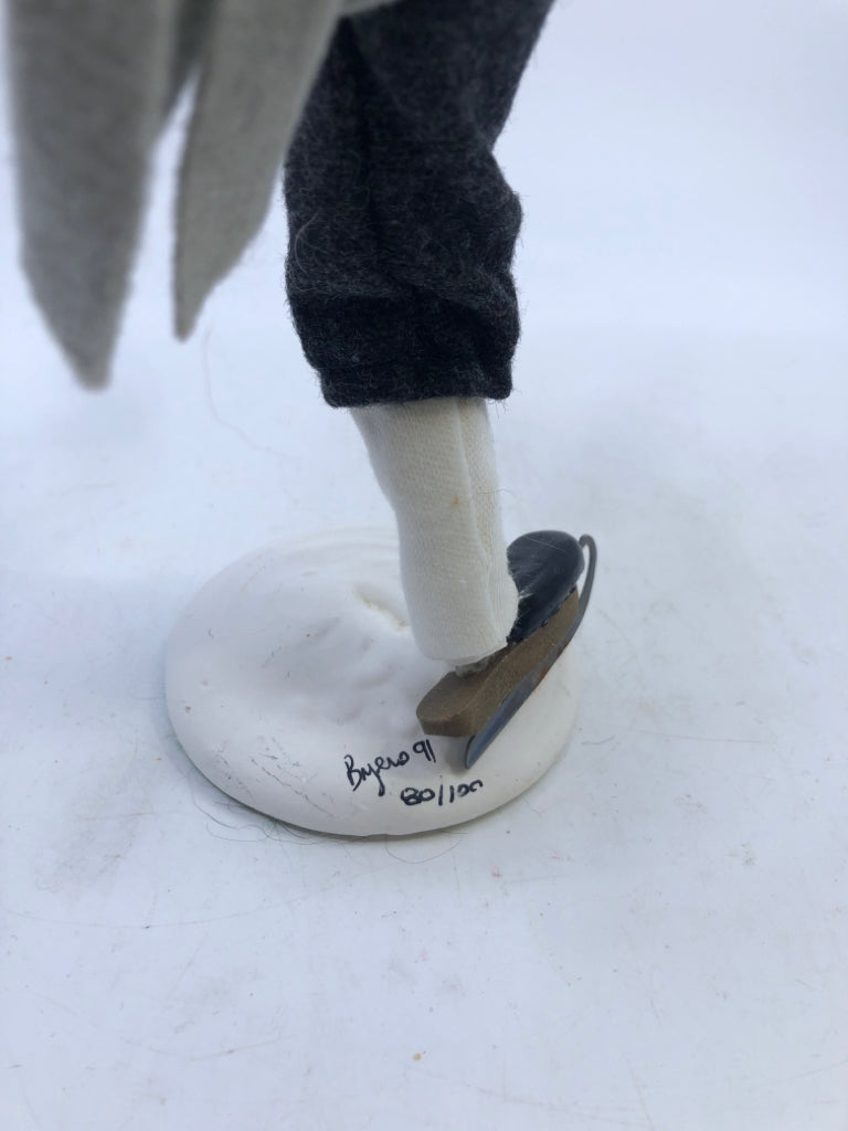 MAN IN GREY COAT W/BLUE & WHITE PLAID SCARF "THE SKATERS" 1991 BYERS' CHOICE.