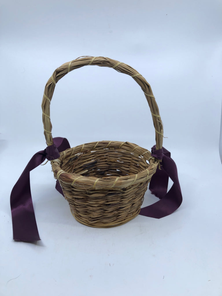 WICKER BASKET W/HANDLE AND PURPLE RIBBONS.