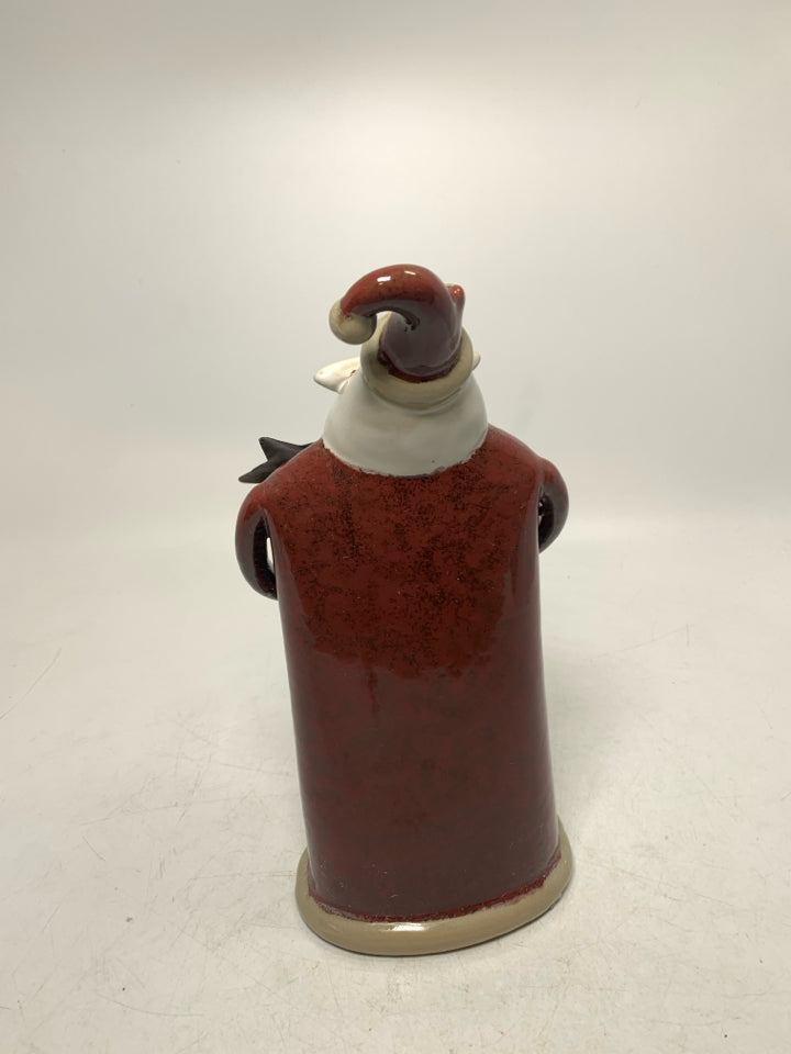 CERAMIC SANTA STANDING W/ HANDS TOGETHER HOLDING GOLD STAR.