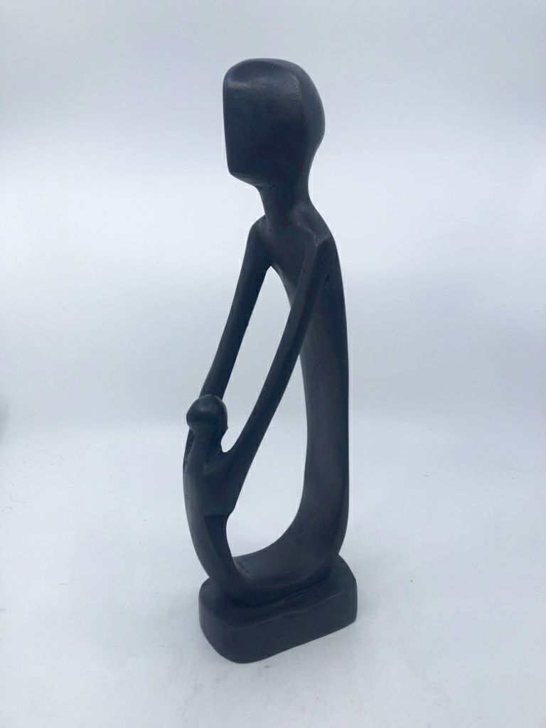 BLACK CARVED ART FORM MAN/CHILD HOLDING HANDS.