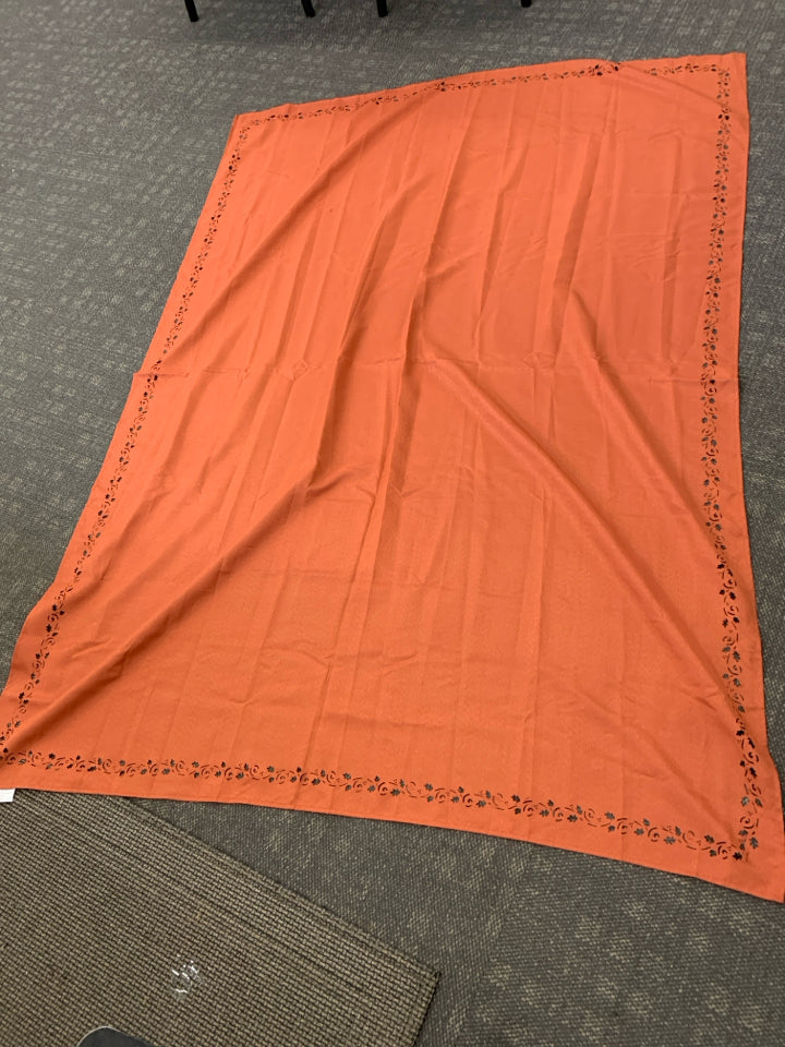 ORANGE TABLECLOTH W/LEAF CUT-OUTS.