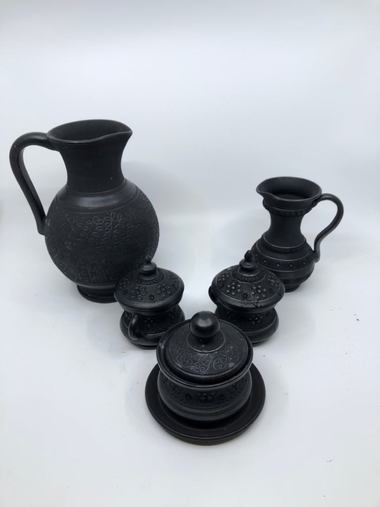 6PC BLACK CARVED TEA SET -PITCHER, CUPS W LID, SUGAR AND CREAMER ON PLATE.