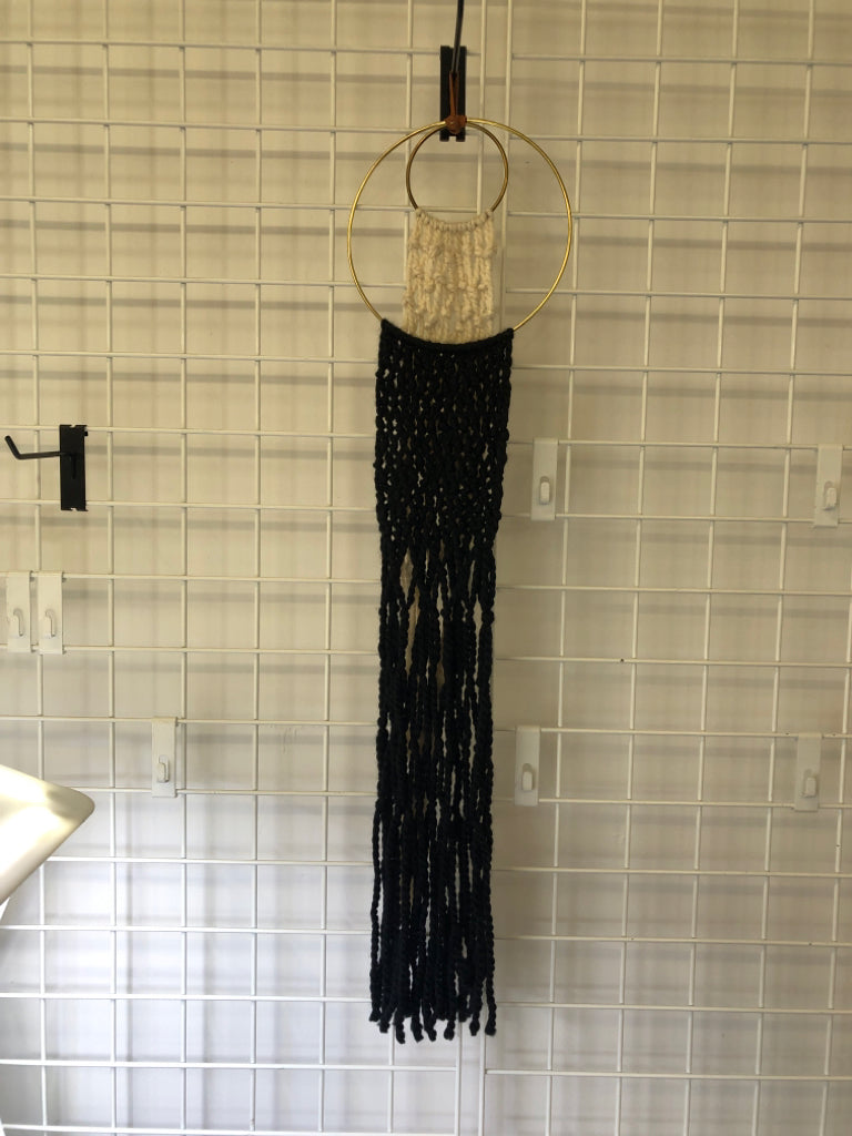BLACK/WHITE MACRAME WALL HANGING W/ 2 GOLD RINGS.