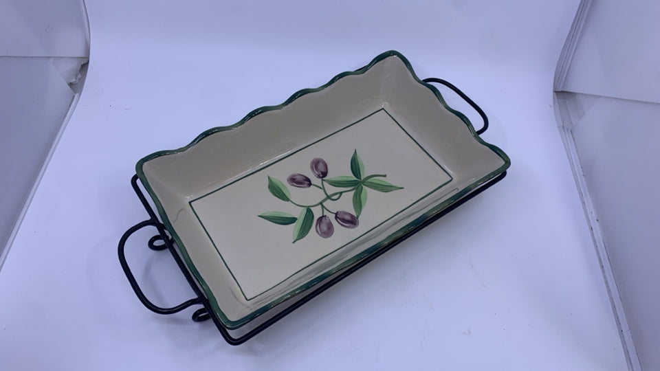 OLIVE CASSEROLE DISH IN METAL HOLDER.