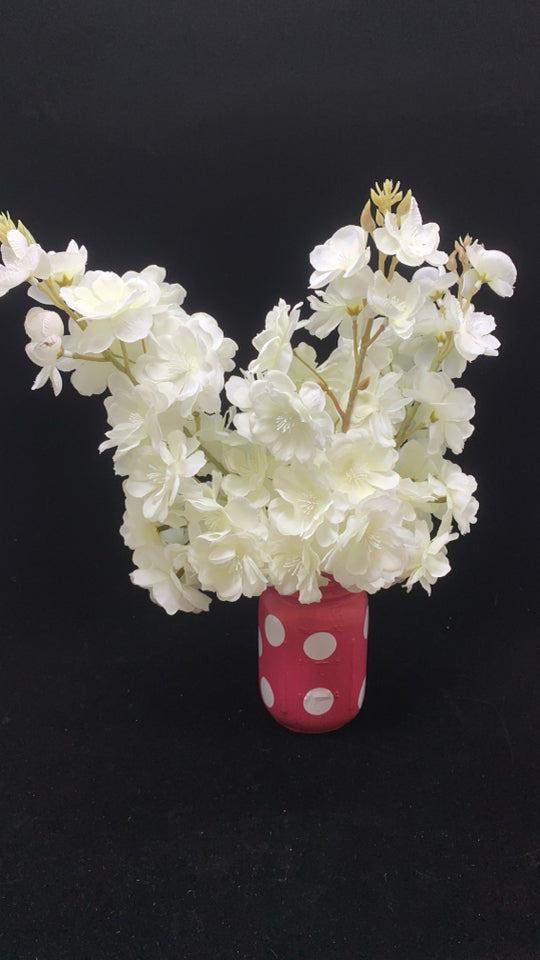WHITE FAUX FLOWERS IN PINK POLKA DOT JAR.
