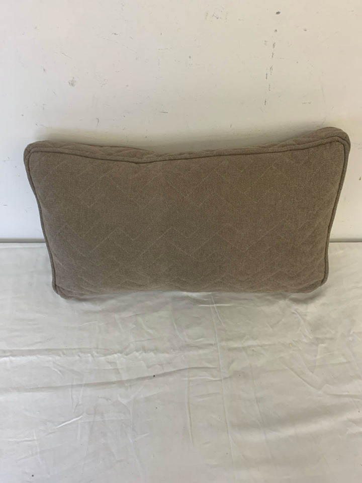 RECTANGLE DARK TAN PILLOW W/ ZIG ZAG STITCHING.