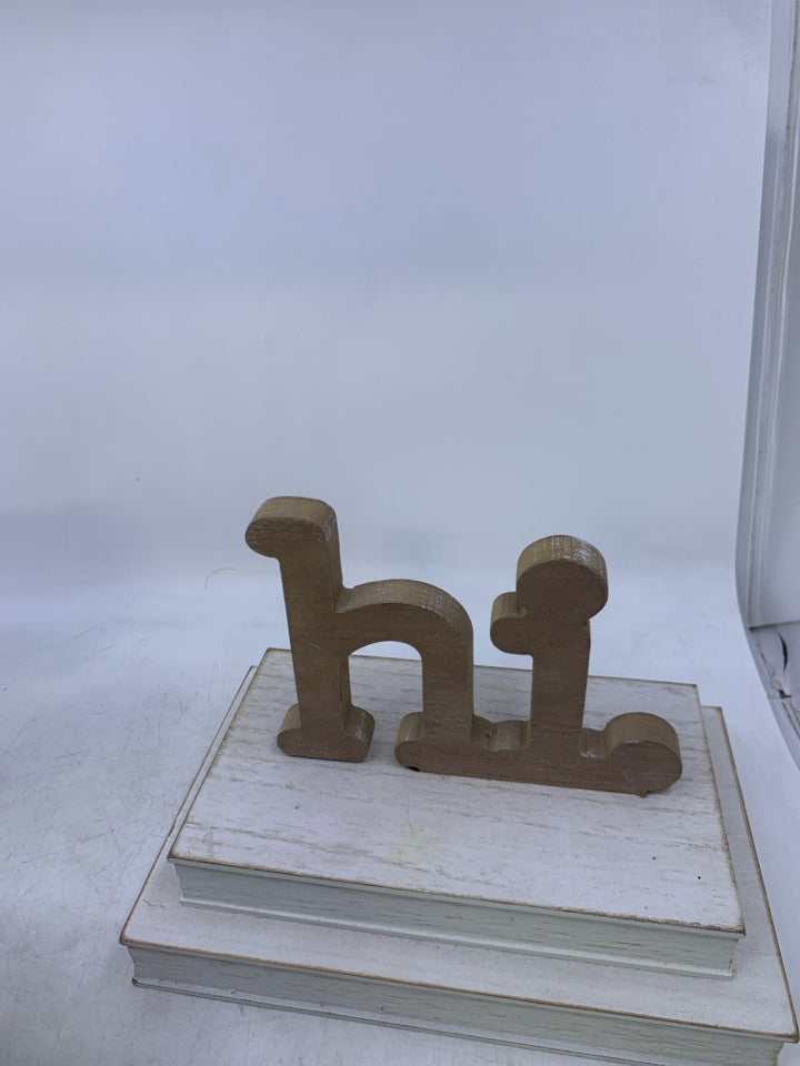 WHITE 2 STACKED BOOKS W/ HI ON TOP.