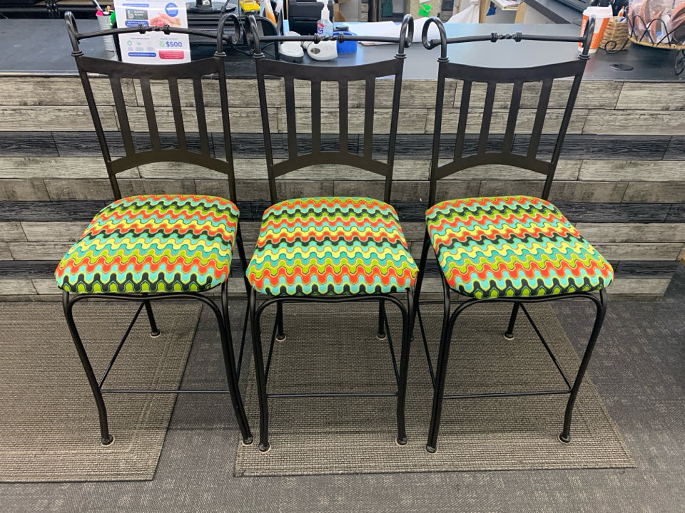 3 METAL SCROLL BAR STOOLS W/COLORFUL UPHOLSTERED SEAT.
