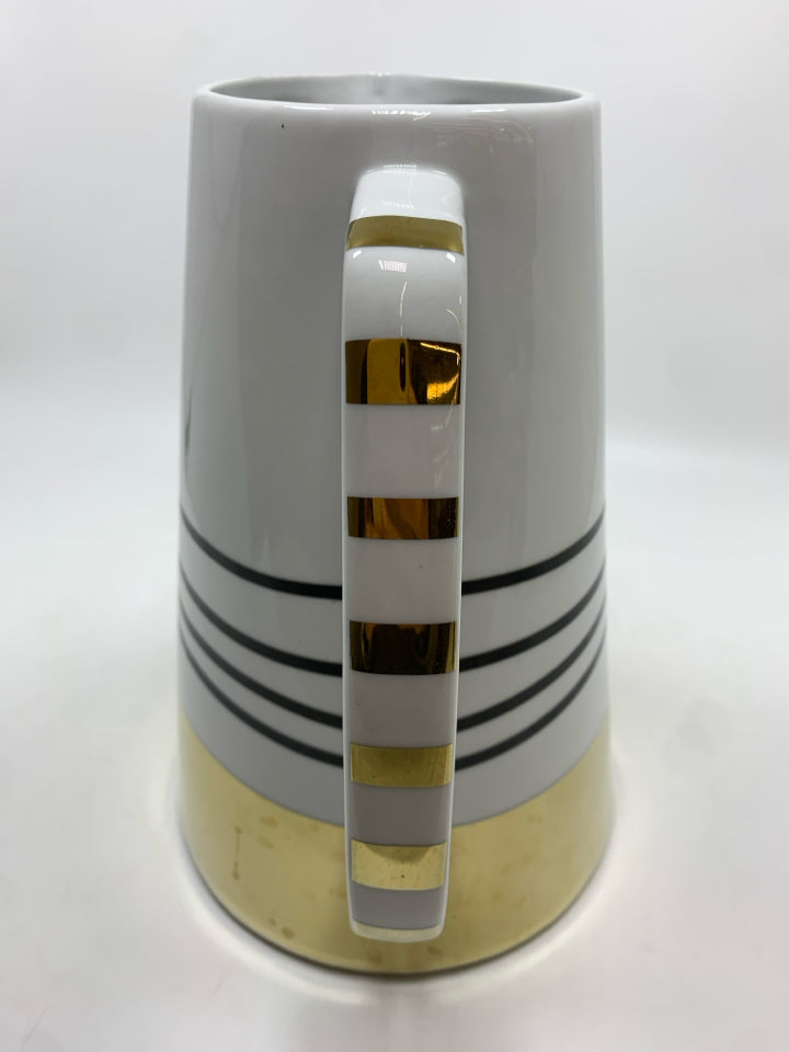 WHITE CERAMIC PITCHER W/BLACK AND GOLD STRIPES.