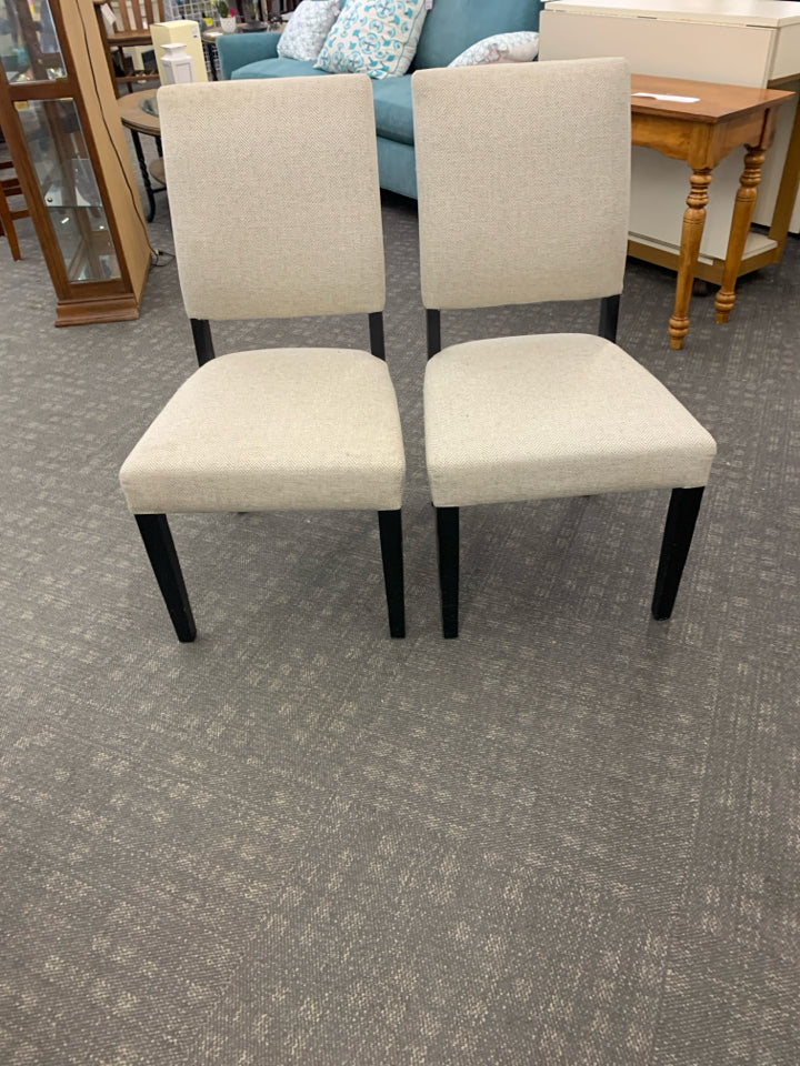 2 CREAM ACCENT CHAIRS W/ BLACK LEGS.