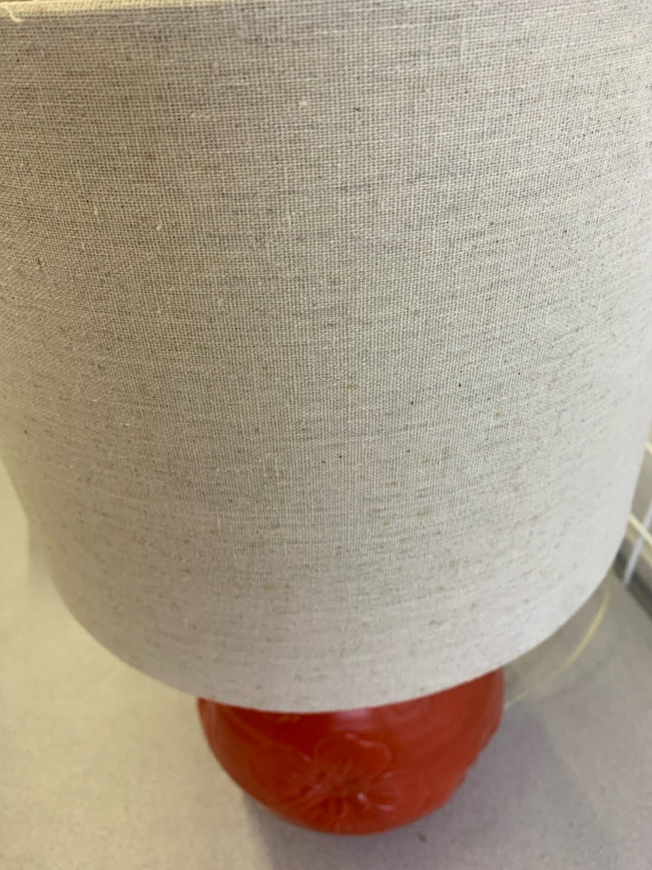 RED CERAMIC BASE W/ EMBOSSED FLOWERS TEXTURED SHADE.