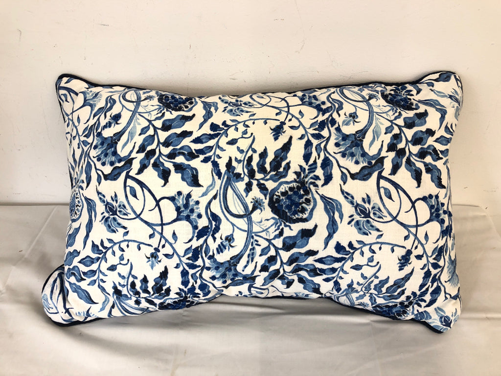 RECTANGLE PILLOW W/ BLUE FLORAL DESIGN- WHITE BACKGROUND EMBOSSED STITCHING.