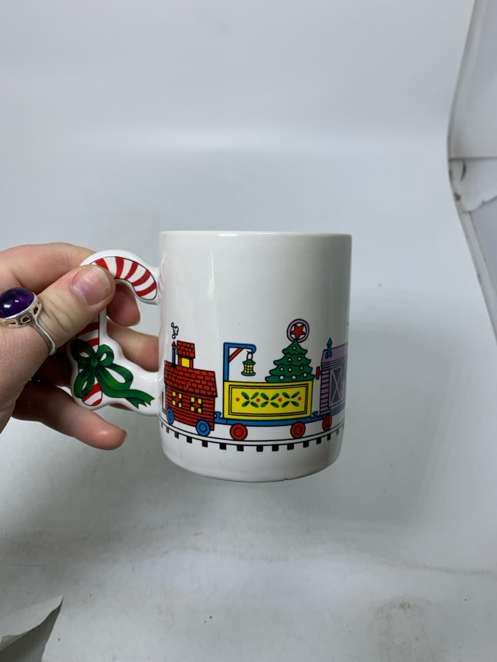 VTG WHITE MUG W/ CANDY CANE HANDLE TRAIN AROUND.