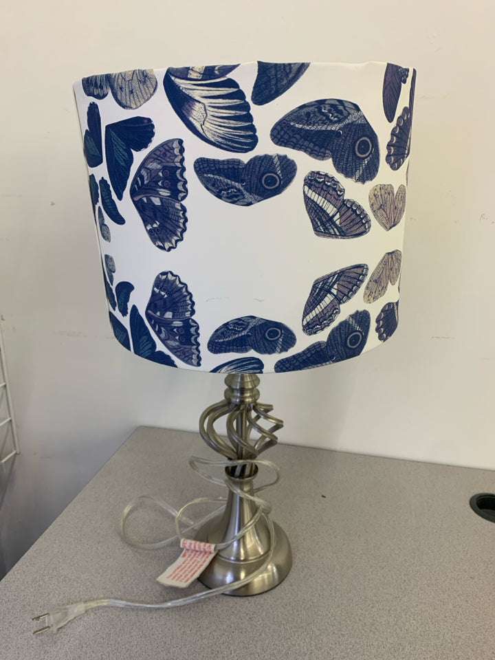 SILVER SWIRL TABLE LAMP WITH WHITE BLUE BUTTERFLY SHADE.