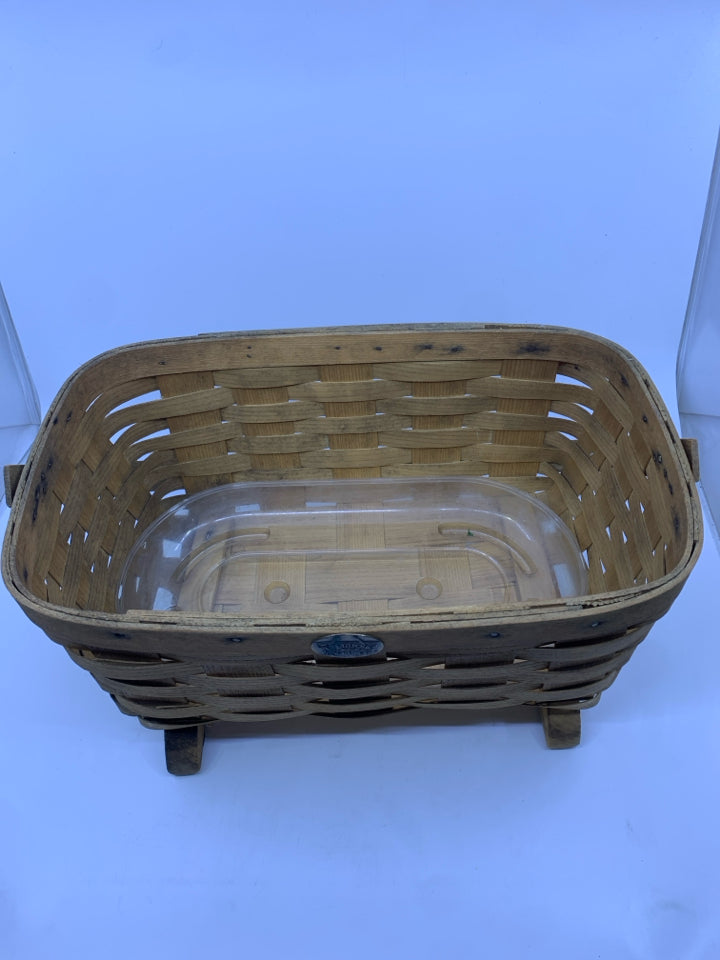 FOOTED PETERBORO BASKET W PLASTIC LINER AND HANDLE.